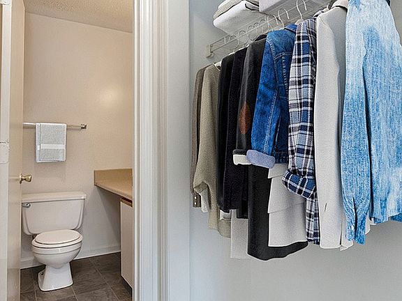 Experience the harmony of design in this convenient closet with connected bathroom.