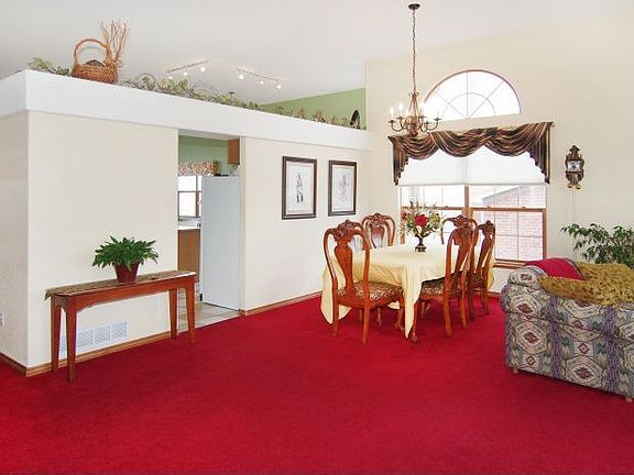 2012 July wall between dining/parlor. Dining has laminate, and entry is tile.