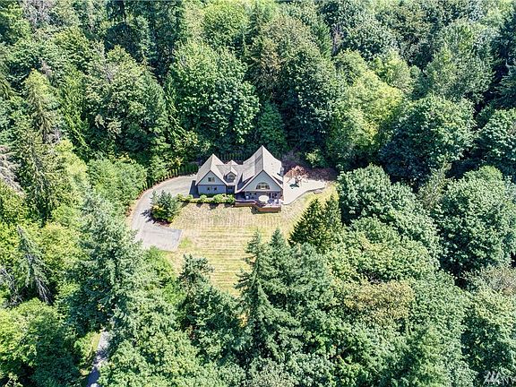 2 Car garage, RV parking next to garage, tons of additional parking and surrounded by trees