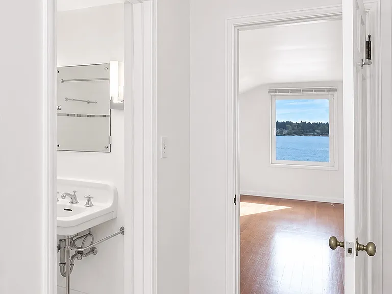 primary bedroom ensuite bathroom and closet with lake view
