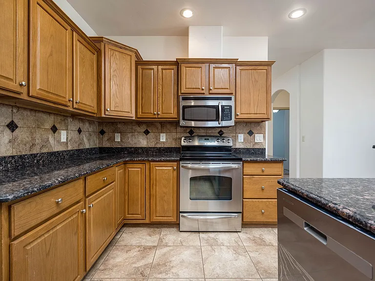 Electric glasstop range & oven, plenty of counter space & cabinets, pullout shelves, lazy susan, DW was replaced this year, r/o under the kitchen sink, garbage disposal replaced. Large pantry with W/D separated by a pocket door.