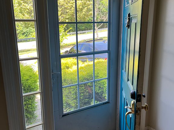 Front view from large foyer showing wooded area across the street