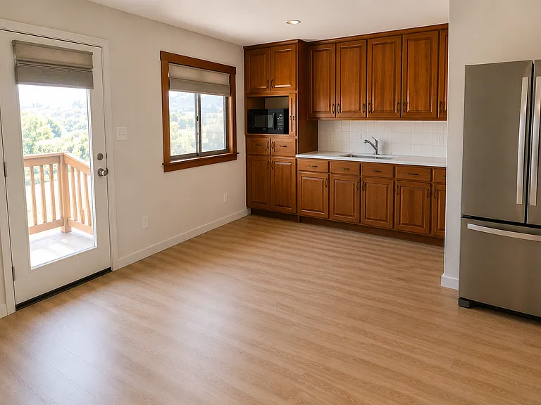 Unfurnished kitchenette area. Microwave included. Newly tiled counter and backsplash