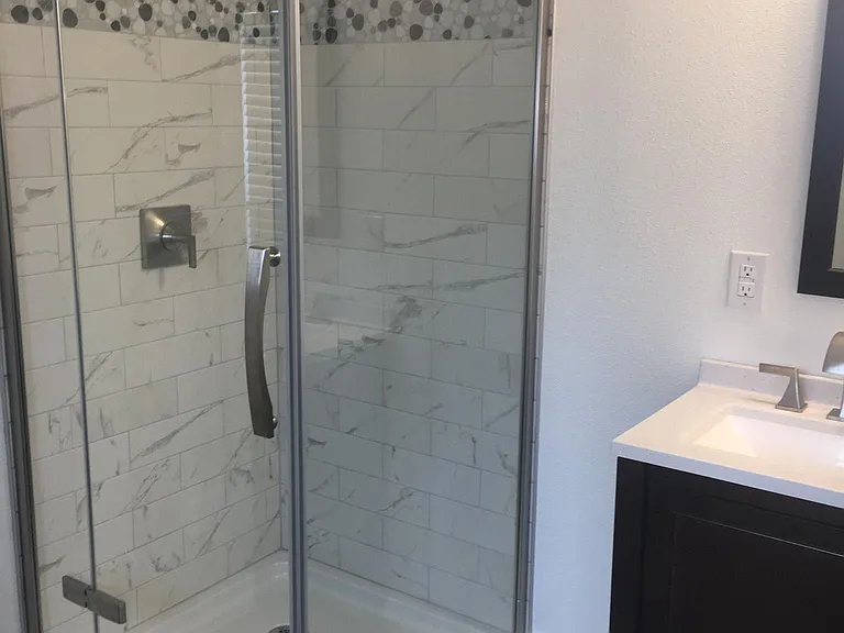 Bathroom shower - tile with glass surround.