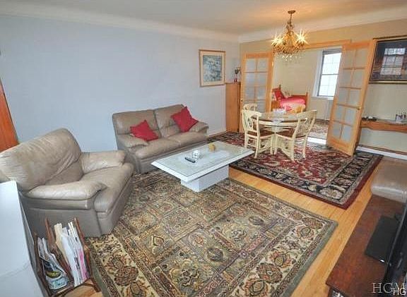 Large bright living room overlooks the courtyard and has refinished hardwood floors.  There are French doors that open to a dining room that is currently being used as a second bedroom.  The room is 18'-0" x 14'-2"