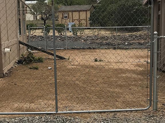 Big Gate to access back yard. One tenant stored ATV in little shed.