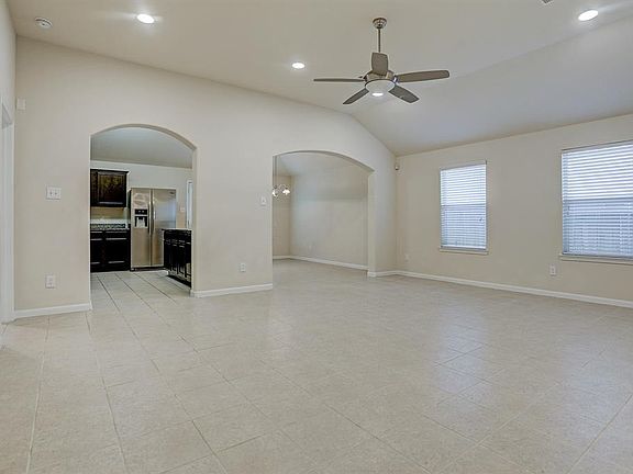 The living room opens up beautifully to the kitchen and dining areas, framed with 2 timeless arches. Tile floors area easy to maintain, easy to impress, and a perfect contemporary backdrop for any style. Master bedroom is off the left before entering