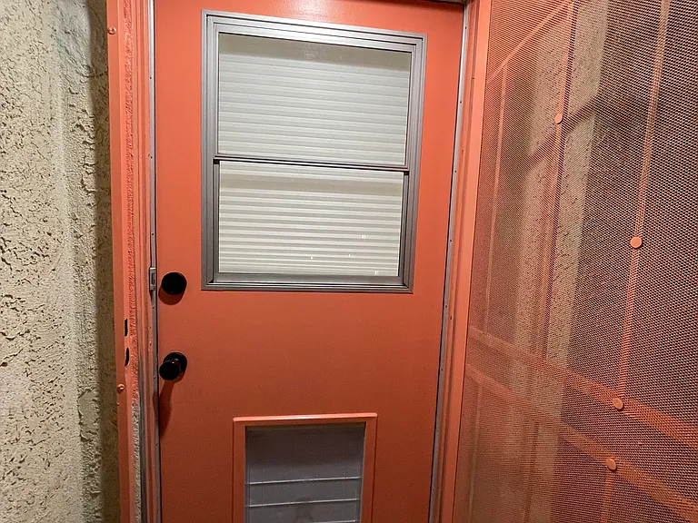 Front entry door with single hung window & extra large doggy door (shown with cover on)