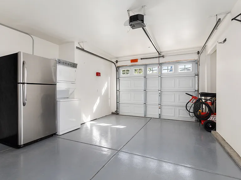 1 car garage with stacked washer/dryer and extra refrigerator (can be removed if not needed)