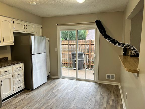 Kitchen with sliding door to patio and open to LR