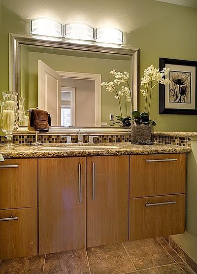 Bathroom features canyon Crrek cabinets & slab granite countertops.