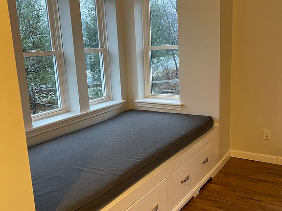 Custom professionally built in window seat with storage, window seat can double as a bed for a guest