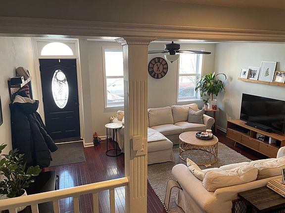 View of living room and front door from the stairs