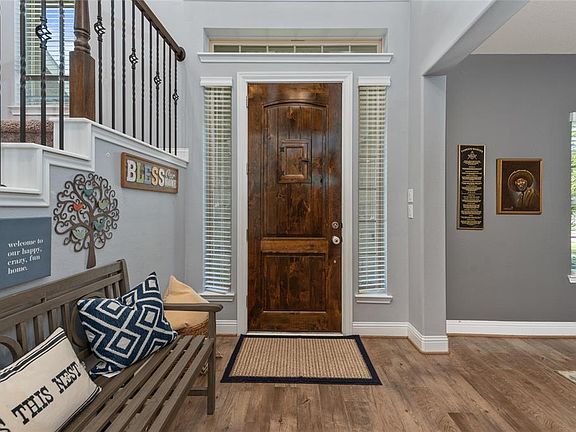 Step inside and instantly feel the warmth of this amazing home! The front door is surrounded by transom windows, sidelight windows and a peek-a-boo window to view who is at the front door!