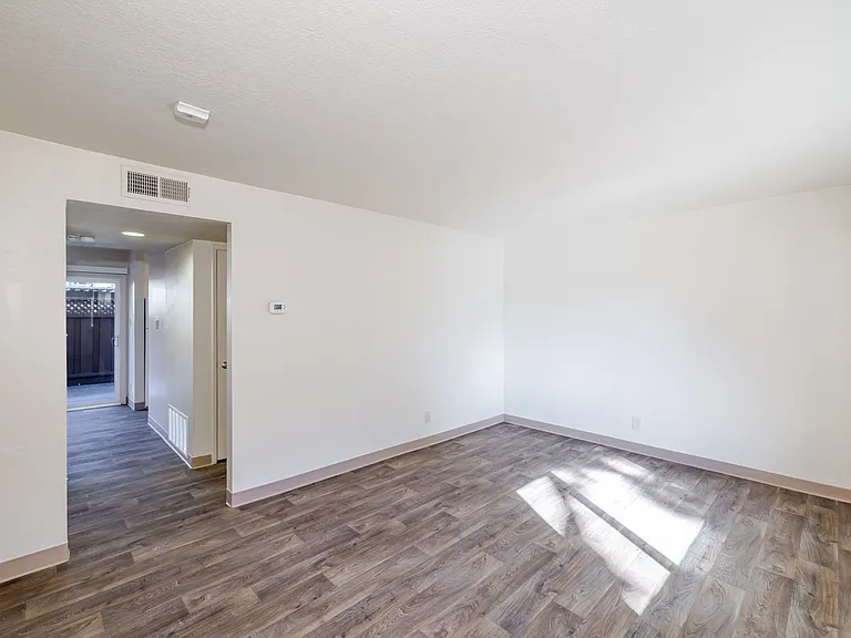 Living area filled with natural light and durable wood-style flooring for everyday comfort.
