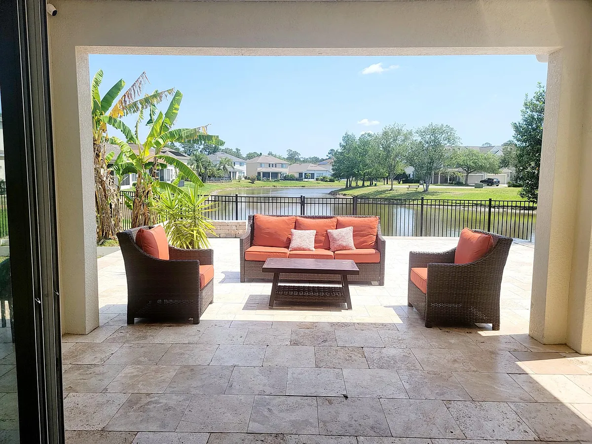1000 sq ft Spacious travertine stone flooring designed for true Florida living with lake view - 3919 Highgate Ct