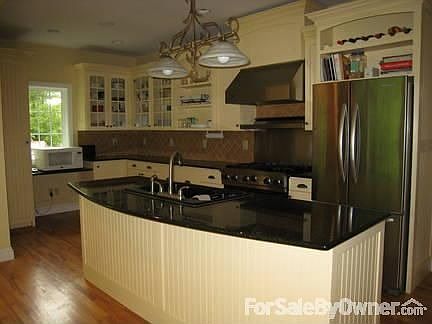 Kitchen has island and professional oven