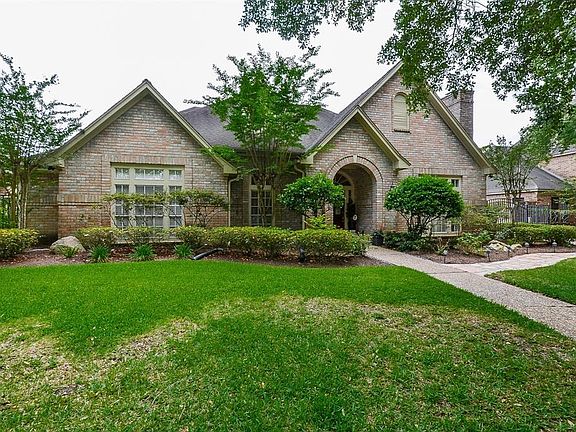 Over sized lot with lush landscape and mature trees add to the desirable curb appeal.