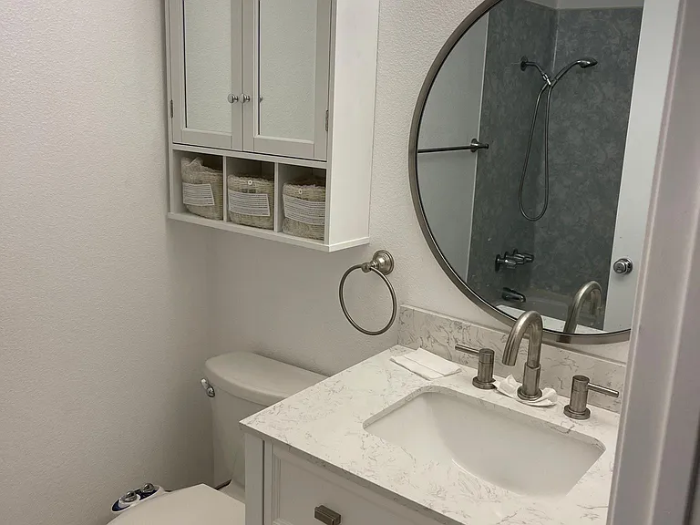 Remodeled bathroom, new cabinets, mirror, flooring and fresh paint.