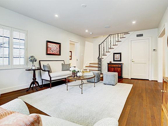 This view from the southern point of the living room gives you a full look at the space and the gracious staircase.