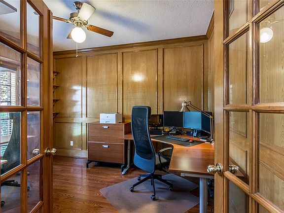 Study with upgraded wood paneling and french doors