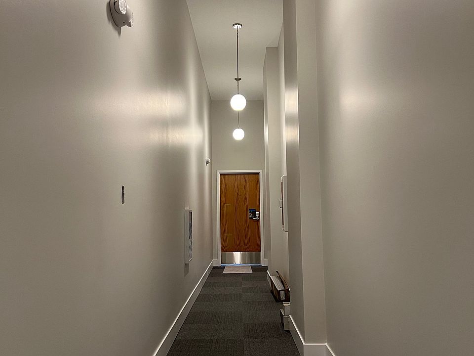 Hallway with apartment entrance #1 showing and #2 to the right.