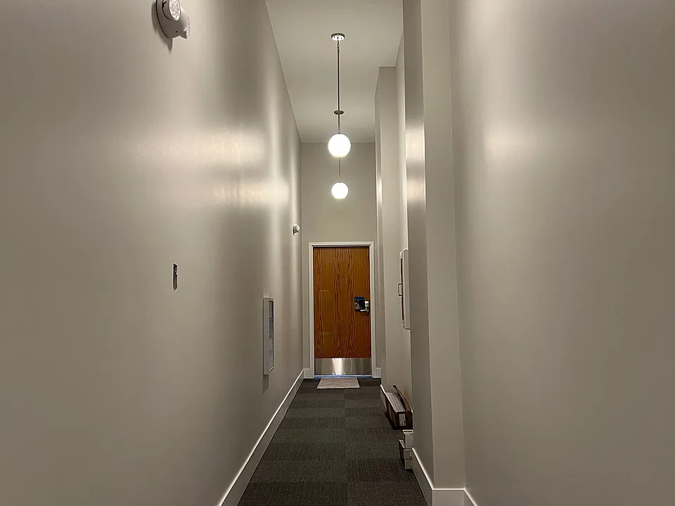 Hallway with apartment entrance #1 showing and #2 to the right.