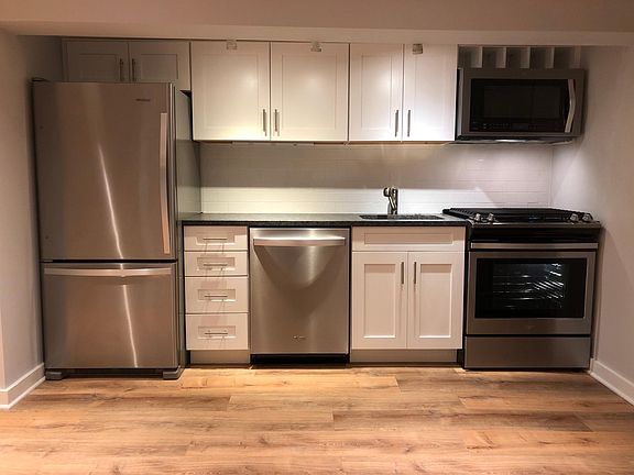 Stainless steel and granite kitchen with gas range, over the range microwave with convection, dishwasher and full-size refrigerator with ice machine