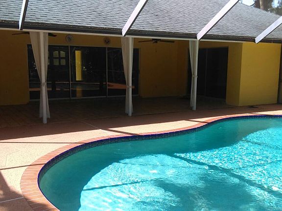 pool receives sun all day, nice covered lanai