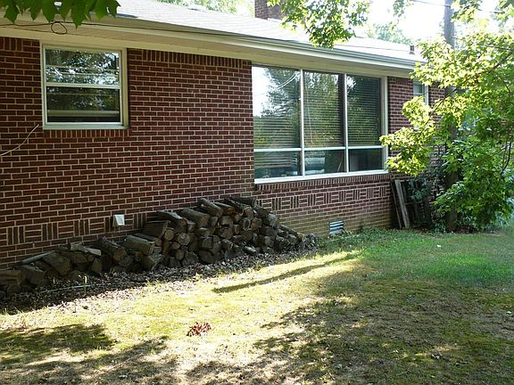 Large picture window in family room overlooks the beautiful back lawn
