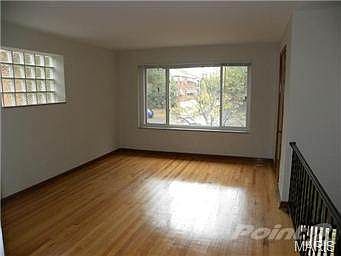 Living room with large picture window and refinished hardwood fl