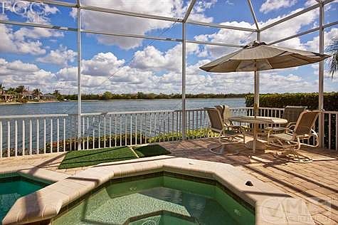 spa and seating area with view of lake