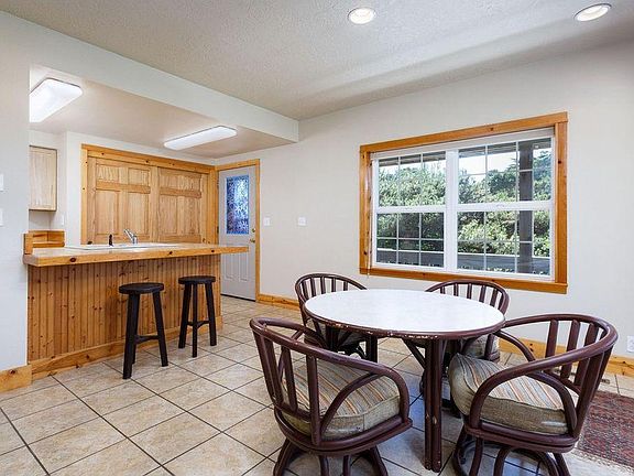 View from dining area to kitchen, entry door and front porch.