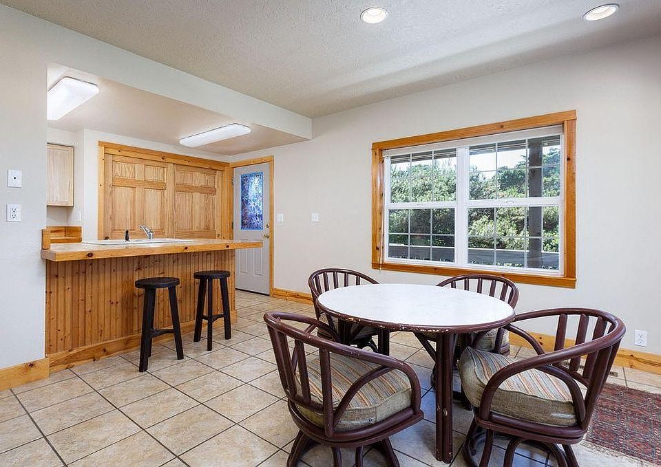 View from dining area to kitchen, entry door and front porch.