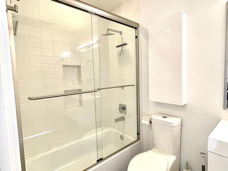 Subway tiles in the shower/tub, plus extra storage