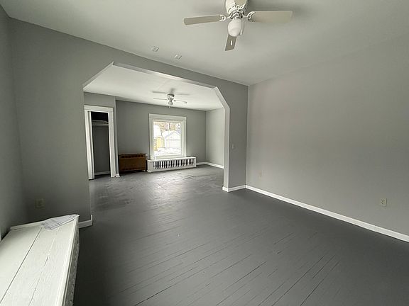 Living room leading to dining room. there are 2 built in benches under the windows