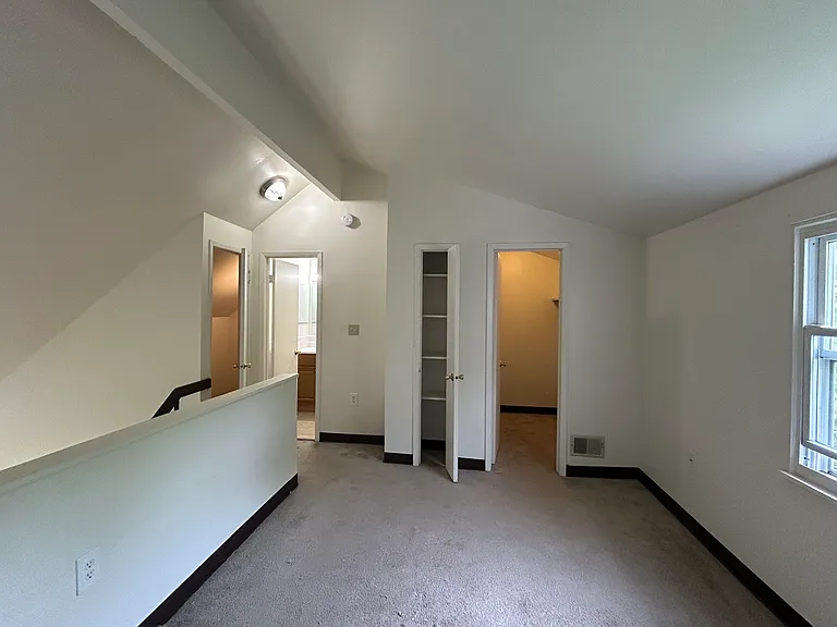 One Primary Bedroom with open loft to first floor. Original bath in this photo. Bath color of tile and fixture may vary.