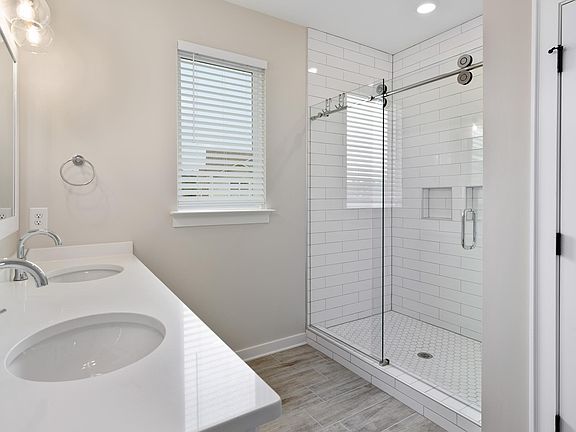 primary bathroom with dual-sink vanity and private toilet closet
