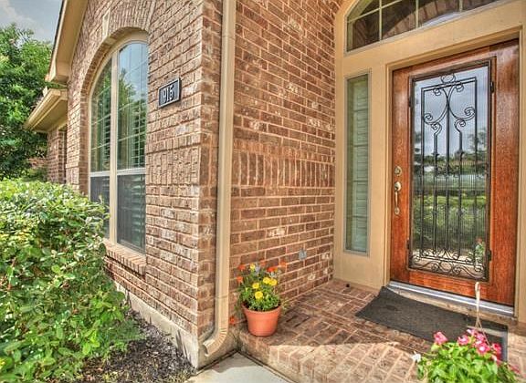 The professionally landscaped home and beautiful front entrance make this home inviting to friends and family.