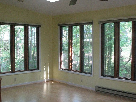 Florida Room with hardwood floors overlooking natural setting