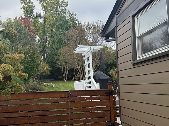 Fenced back yard and parking by house