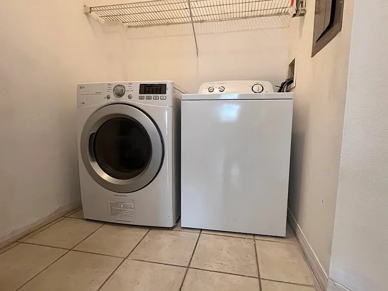 Laundry Room With Pantry and Water Heater