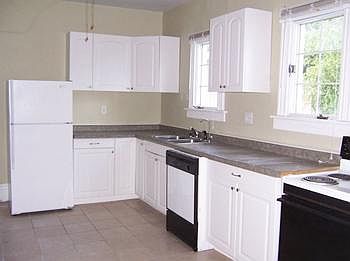 Updated kitchen includes electric range, refrigerator & dishwasher