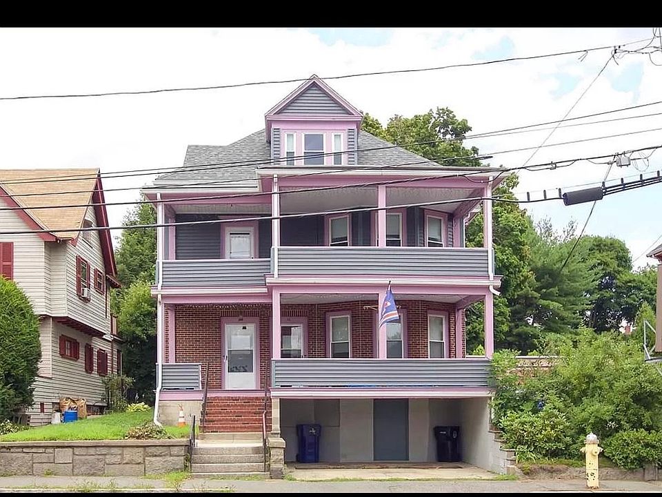 Front exterior with covered porch and parking.