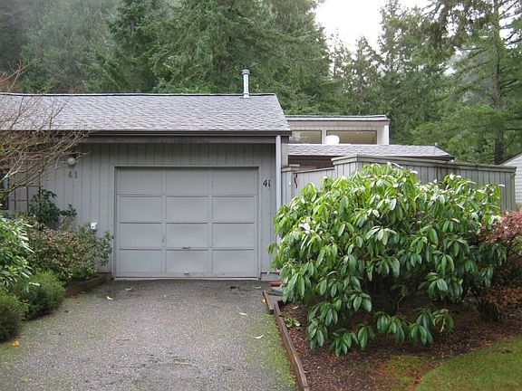 Single garage with opener with additional driveway parking and guest parking next door.