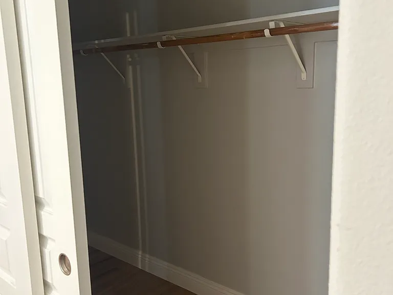 Primary bedroom closet. Semi-walk in.