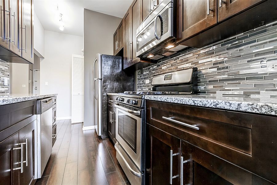 Updated kitchen with granite counter top and stainless steel appliances