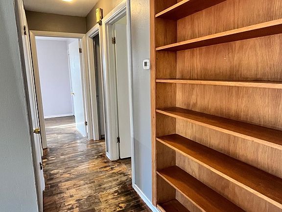 Built in bookshelves in living room on the way to bedrooms