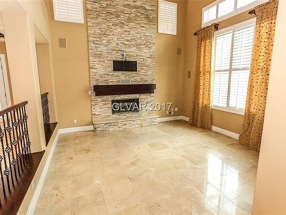 FORMAL SUNKEN LIVING ROOM WITH STACKED STONE FIREPLACE