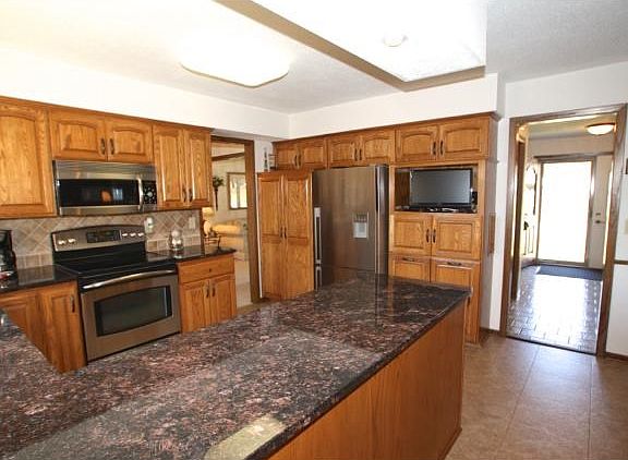 Extra wall of cabinets including garbage & recycling drawers.